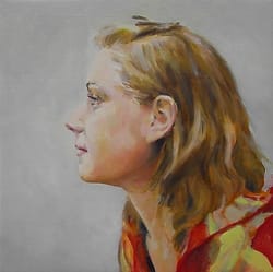 Young woman seen from the side with flowing hair.