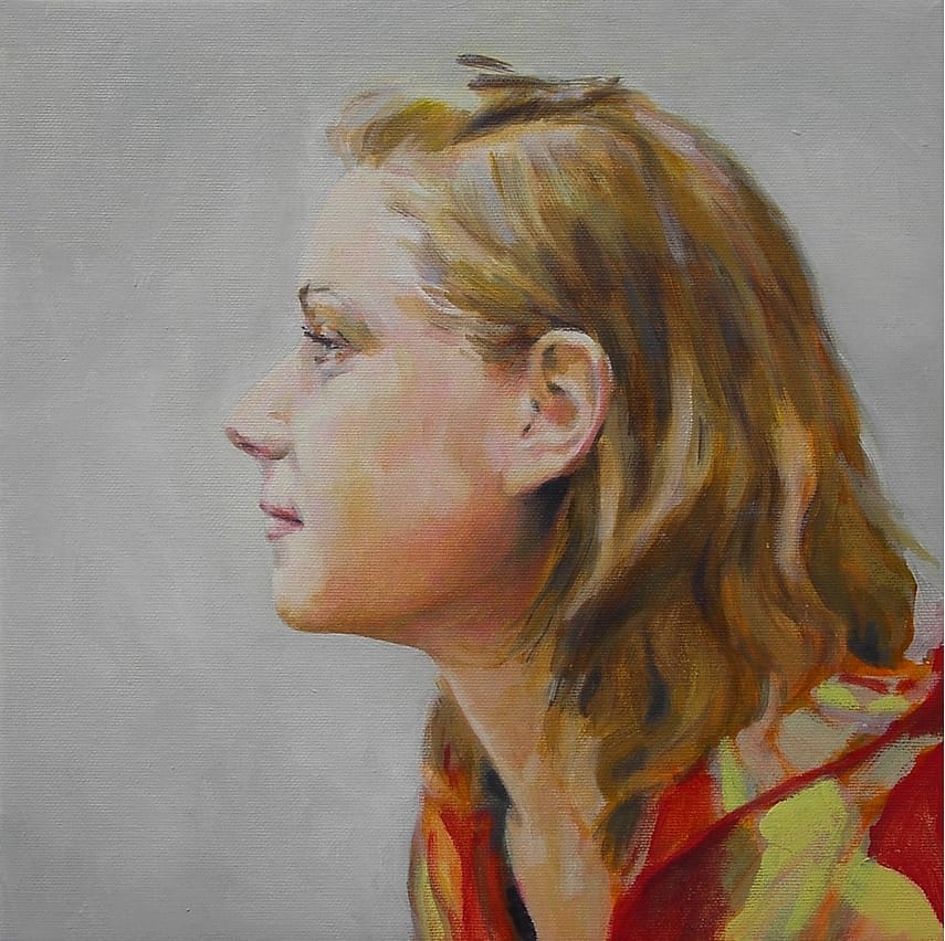 Young woman seen from the side with flowing hair.