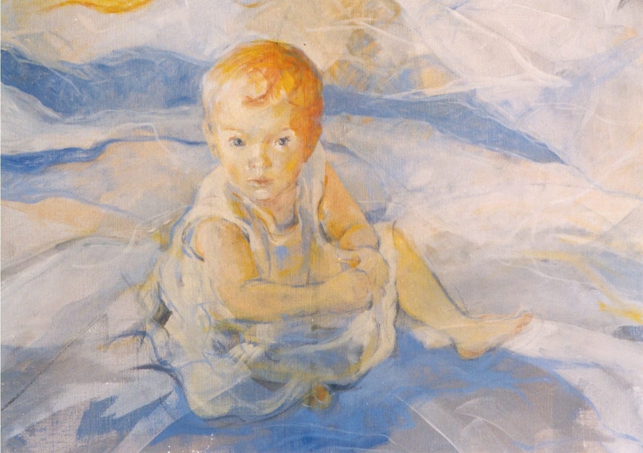 Portrait of a toddler girl sitting on the ground and looking up, seen from above.