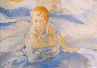 Portrait of a toddler girl sitting on the ground and looking up, seen from above.